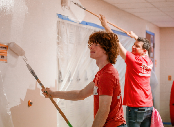  Two members of the James River Serve Team paint interior walls at Cherokee Middle School.